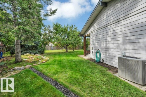 Looking to back of property with fruit trees and extensive landscaping. Central A/C unit included. - 895 Lee Ridge Road Nw, Edmonton, AB 