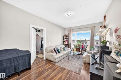 Wood-finish flooring throughout, bright walls, and a large window - #404 12804 140 Av Nw, Edmonton, AB 