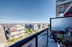 Balcony with clear panel railing, frosted privacy panel, and concrete flooring - 
