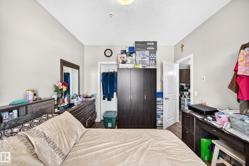 Recessed lighting, wood-finish flooring, and light neutral wall tones - #404 12804 140 Av Nw, Edmonton, AB 