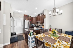 Kitchen featuring stainless steel appliances, dark wood-finish cabinetry, and solid surface countertops - 