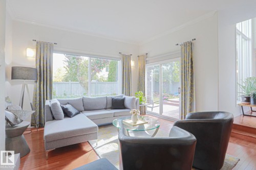 Hardwood-finish flooring, recessed wall lighting, multiple large windows, and sliding glass door leading to outdoor decking - 995 Ogilvie Boulevard Nw, Edmonton, AB 