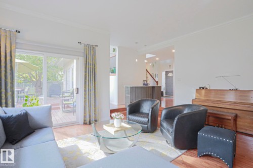 Spacious interior with wood-finish flooring, white walls, and crown molding - 995 Ogilvie Boulevard Nw, Edmonton, AB 