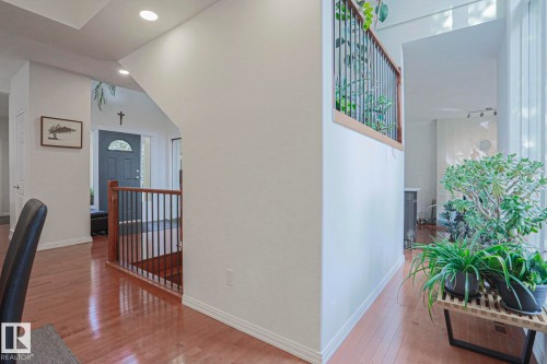 Wood-finish flooring throughout, recessed lighting, and a dark wood and metal railing - 995 Ogilvie Boulevard Nw, Edmonton, AB 