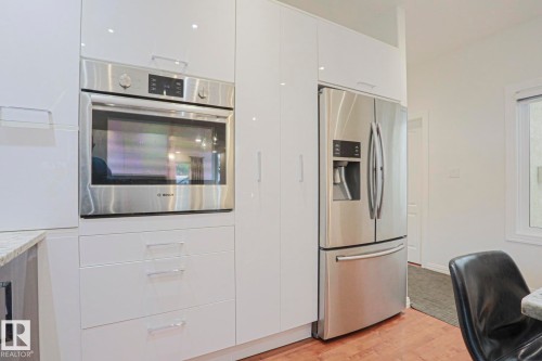 Built-in stainless steel oven, integrated microwave, and stainless steel refrigerator - 995 Ogilvie Boulevard Nw, Edmonton, AB 