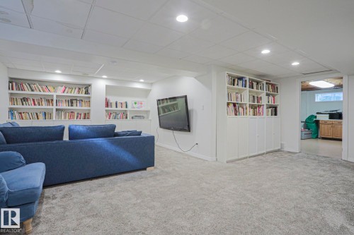 Recessed lighting, built-in shelving, built-in cabinetry, and neutral carpeting - 995 Ogilvie Boulevard Nw, Edmonton, AB 