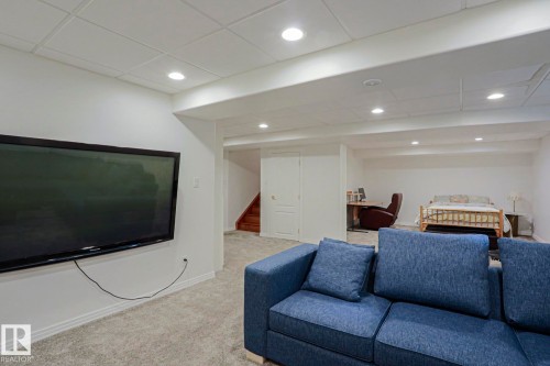 Recessed lighting illuminating the carpeted floor and white walls - 995 Ogilvie Boulevard Nw, Edmonton, AB 