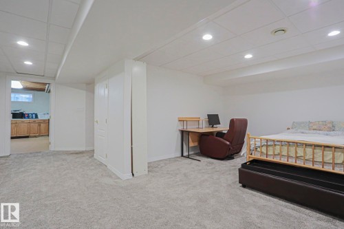 Recessed lighting, wall-to-wall carpeting, and a drop ceiling - 995 Ogilvie Boulevard Nw, Edmonton, AB 