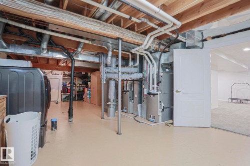 Unfinished basement with exposed ceiling joists and utility infrastructure - 995 Ogilvie Boulevard Nw, Edmonton, AB 