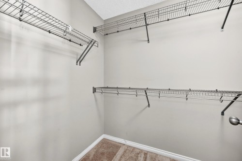 Walk-in closet featuring wire shelving and hanging rods - 21 Silverstone Drive, Stony Plain, AB 