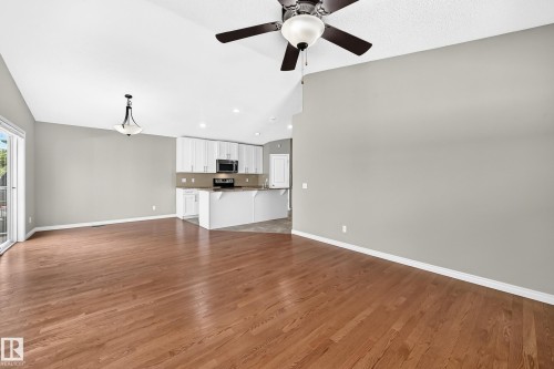 Varnished wood-finish flooring, vaulted ceiling, and recessed lighting - 21 Silverstone Drive, Stony Plain, AB 