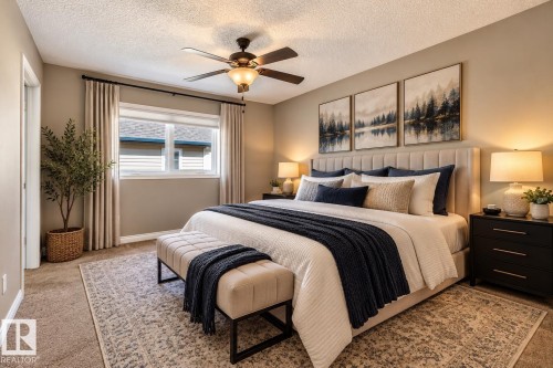 Ceiling fan with integrated lighting, window with blinds, carpet flooring, and a door opening into the space - 21 Silverstone Drive, Stony Plain, AB 