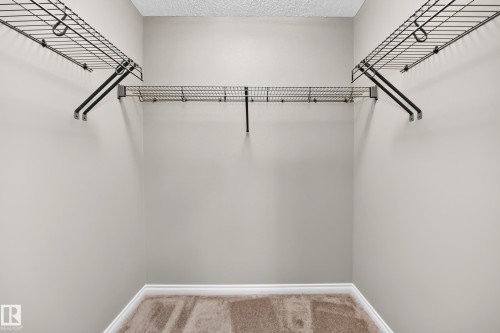 Built-in wire shelving and hanging rods - 21 Silverstone Drive, Stony Plain, AB 