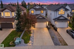 Twilight elegance defines this two-story residence, featuring a modern architectural design with clean lines and neutral exterior finishes - 