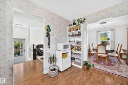 Wood-finish flooring, white trim work, and a ceiling-mounted light fixture - 