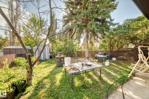 Expansive backyard featuring mature trees, a storage shed, and a privacy fence - 11007 173A Avenue Nw, Edmonton, AB 