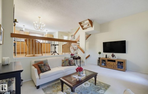 Two-tone wooden staircase with white balusters - 17072 67 Avenue Nw, Edmonton, AB 
