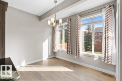 Wood-finish flooring, two large windows, and a built-in light fixture - 