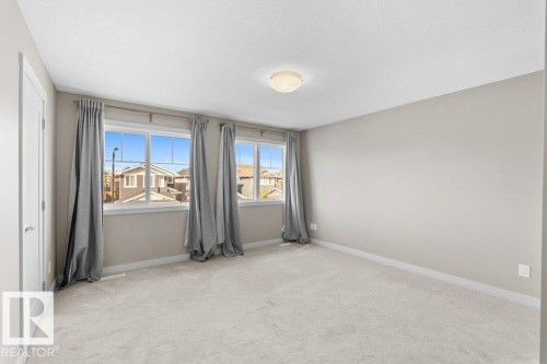Wall-to-wall carpeting and three windows with trim - 1523 168 Street Sw, Edmonton, AB 