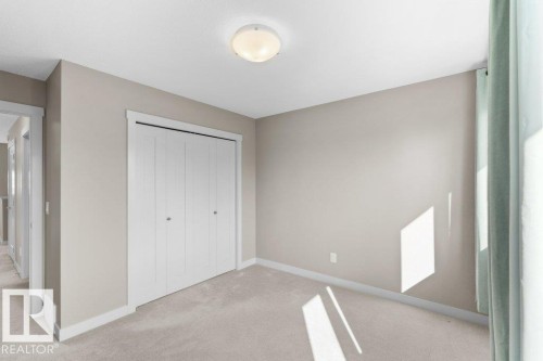 Recessed ceiling lighting, light neutral wall paint, bi-fold closet doors, wall-to-wall carpeting, and white trim - 1523 168 Street Sw, Edmonton, AB 
