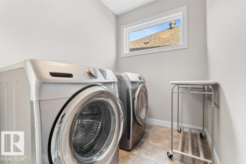 Light gray wall paint, white trim, and a high window - 1523 168 Street Sw, Edmonton, AB 