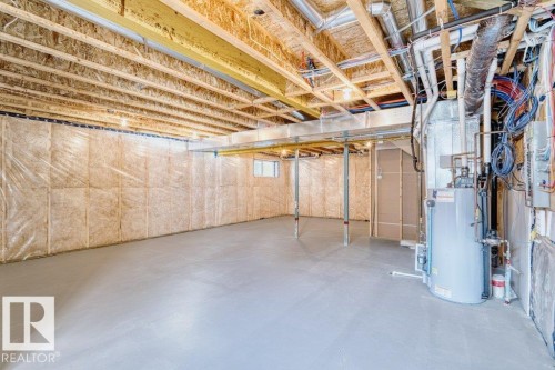 Unfinished basement with exposed ceiling joists, concrete flooring, and insulated perimeter walls - 1523 168 Street Sw, Edmonton, AB 