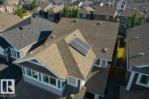 Architectural shingle roofing with solar panels, multiple gables, and white trim accents - 1523 168 Street Sw, Edmonton, AB 