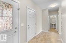 Entryway featuring patterned glass door, neutral wall paint, and tile flooring - 1523 168 Street Sw, Edmonton, AB 