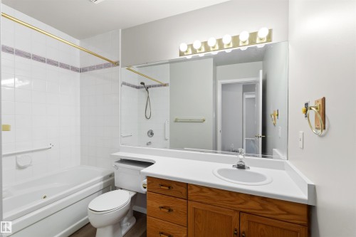 White tile tub and shower combination with decorative accent tile - #408 10610 76 St Nw, Edmonton, AB 