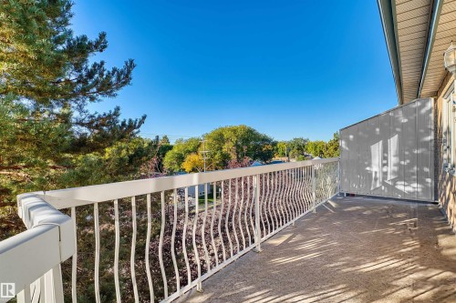 Outdoor balcony featuring a white decorative railing and concrete flooring - #408 10610 76 St Nw, Edmonton, AB 
