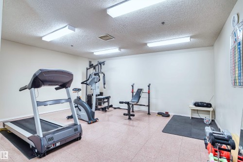 Dedicated fitness room with fluorescent lighting and light-toned walls - #408 10610 76 St Nw, Edmonton, AB 