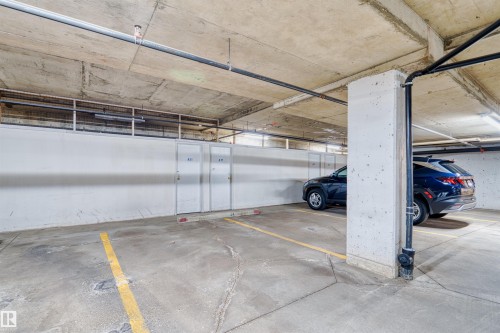 Concrete flooring, reinforced concrete ceiling, exposed piping, interior lighting, and storage units - #408 10610 76 St Nw, Edmonton, AB 