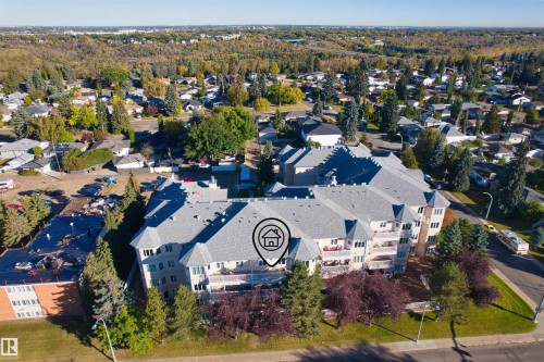 Multi-story building featuring balconies, gabled rooflines, and dormer windows - #408 10610 76 St Nw, Edmonton, AB 