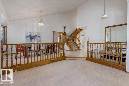 Vaulted ceilings, wood-finish railings, recessed lighting, and a prominent staircase - 507 Burton Close Nw, Edmonton, AB 