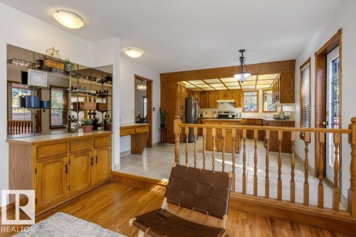 Kitchen featuring wood cabinetry, tiled flooring, and a drop ceiling with recessed lighting - 507 Burton Close Nw, Edmonton, AB 