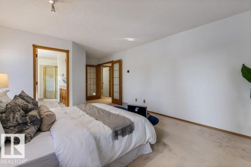Recessed lighting, wood-finish trim, paneled doors, and neutral carpeting - 507 Burton Close Nw, Edmonton, AB 