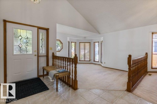Vaulted ceilings, leaded glass entry door, tiled entryway, wood railing, and bay windows - 507 Burton Close Nw, Edmonton, AB 