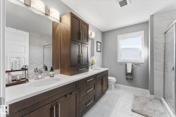 Dual vanity with built-in cabinetry, an integrated sink, and white countertops - 