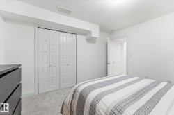 Carpeted flooring, white walls, white paneled doors, and ceiling lighting - 