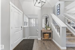 Entryway featuring wood-finish flooring and a white paneled door - 