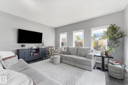 Recessed lighting, light gray wall color, dark wood-finish flooring, white window trim, and multiple windows - 