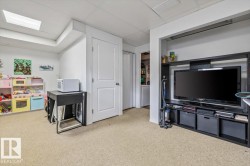 Carpeted flooring with white painted walls and ceiling, featuring a rectangular ceiling light fixture - 