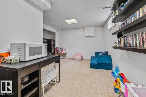 Carpeted flooring, recessed lighting, and wall-mounted shelving - 1040 Lakewood Rd N Nw, Edmonton, AB 