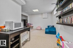 Carpeted flooring, recessed lighting, and wall-mounted shelving - 