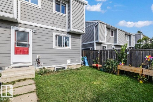 Exterior with gray horizontal siding, white trim, and a red entry door - 1040 Lakewood Rd N Nw, Edmonton, AB 