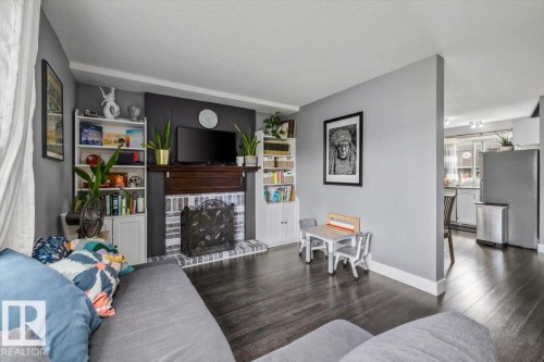 Living area featuring a dark wood-finish flooring - 1040 Lakewood Rd N Nw, Edmonton, AB 