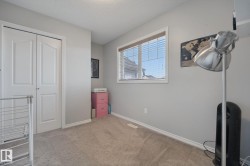 Wall-to-wall carpeting, window with horizontal blinds, and a built-in closet with bi-fold doors - 