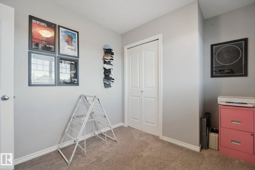 White bi-fold closet doors, light gray wall paint, and gray carpeting - 324 Ascott Crescent, Sherwood Park, AB 