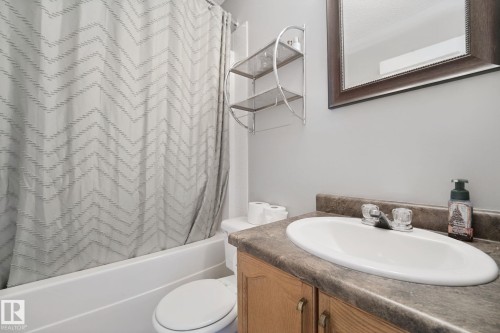 Vanity with a built-in sink, framed mirror, and a built-in bathtub with shower - 324 Ascott Crescent, Sherwood Park, AB 