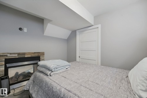 Recessed electric fireplace with stone-finish surround - 324 Ascott Crescent, Sherwood Park, AB 